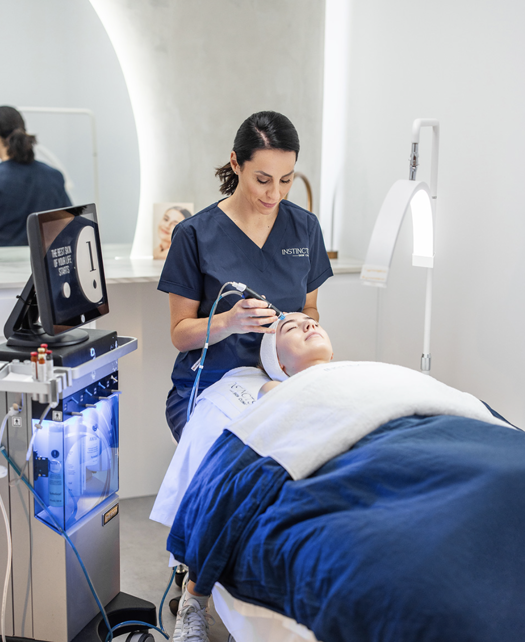 An Instincts dermal clinician performing a HydraFacial skin treatment in the Bella Vista clinic